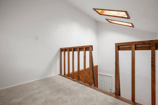 Bonus room with lofted ceiling with skylight and carpet | Image 9