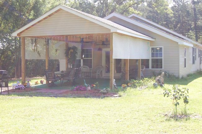 View of front of home with a front yard and a patio | Image 27