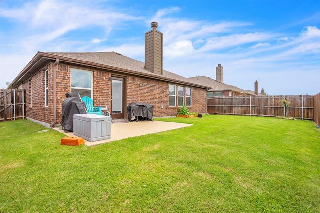 Rear view of property featuring brick siding, a patio, a fenced backyard, and a chimney | Image 29