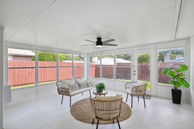Sunroom with a ceiling fan, healthy amount of natural light, and an outdoor living space | Image 29