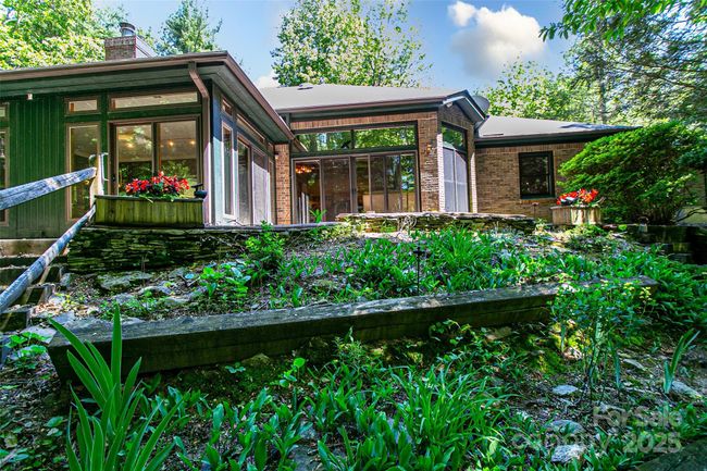 Back yard looking toward the four season room and the primary suite | Image 37