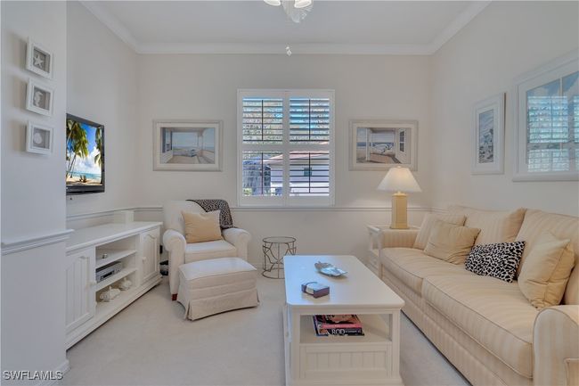 Living area with plenty of natural light, light carpet, crown molding, and ceiling fan | Image 7