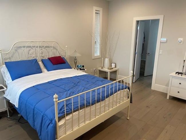 Bedroom with baseboards and wood finished floors | Image 8