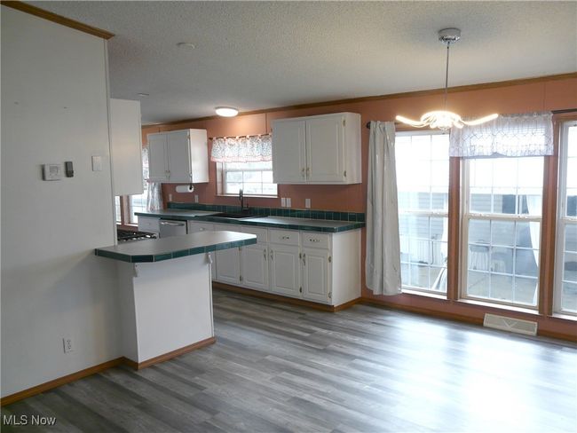 Kitchen with white cabinetry | Image 5