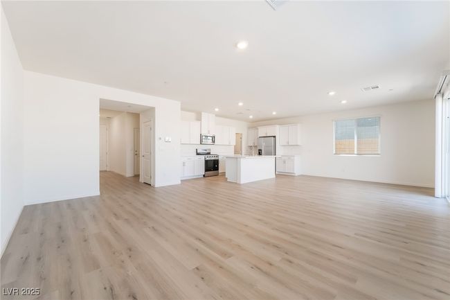 Unfurnished living room with light wood-style floors and recessed lighting | Image 5