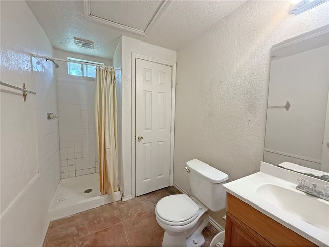 Full bath with vanity, toilet, a stall shower, a textured wall, and a textured ceiling | Image 8