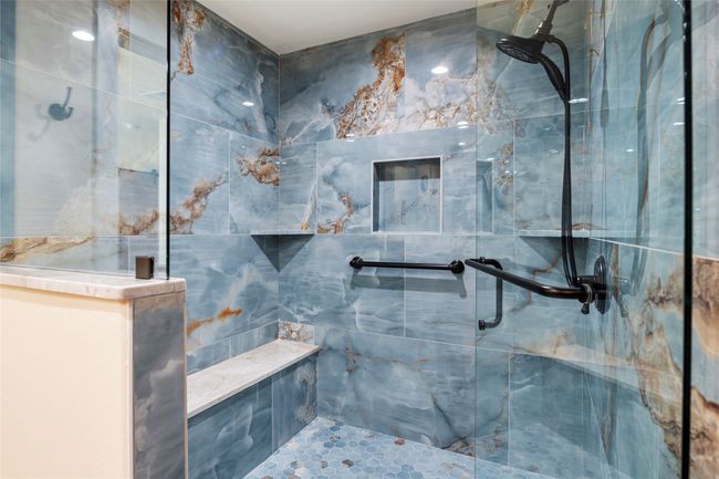Look at how beautiful this shower is with a bench and grab bars, along with a wheelchair accessible entrance | Image 18