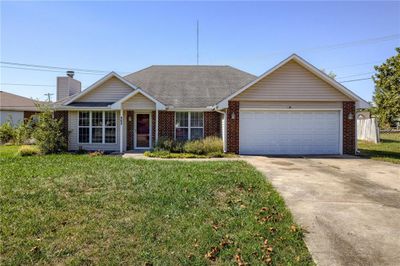 Single story home featuring a front yard and a garage | Image 1