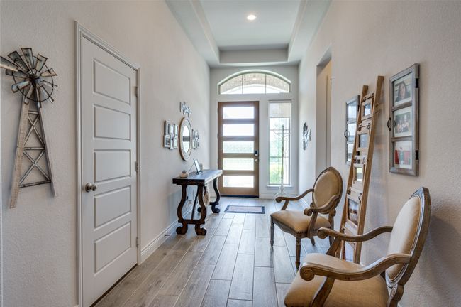 Foyer with wood finished floors, baseboards, a raised ceiling, and recessed lighting | Image 4