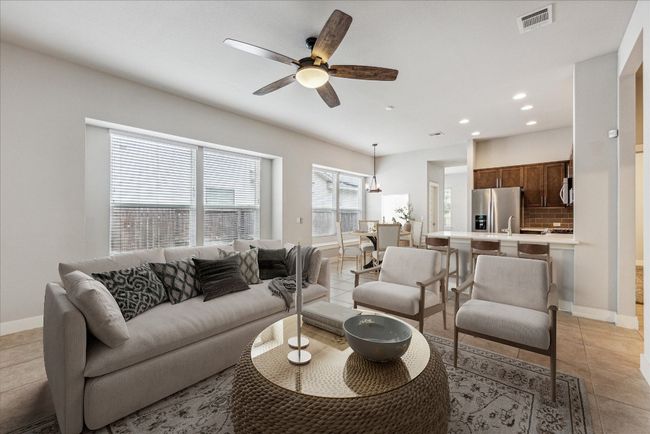 Living room with recessed lighting, baseboards, ceiling fan, and light tile patterned floors | Image 6