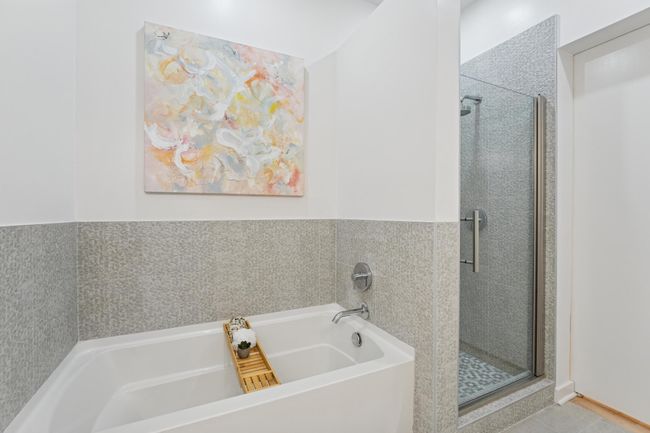 A deep soaking tub and glass-enclosed shower provide options for both rejuvenation and relaxation. | Image 23