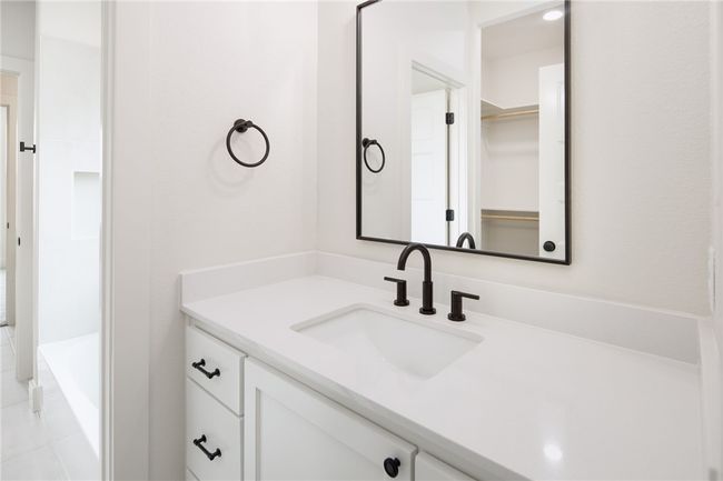 Bathroom with vanity and a tub to relax in | Image 28