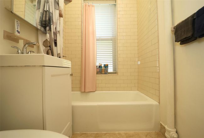 Full bath with toilet, tile patterned flooring, vanity, and shower / bath combination with curtain | Image 11