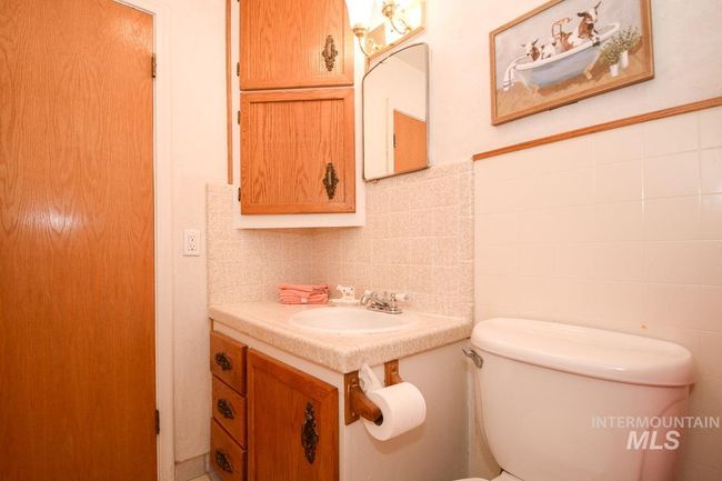 Half bath with tile walls, vanity, and backsplash | Image 25