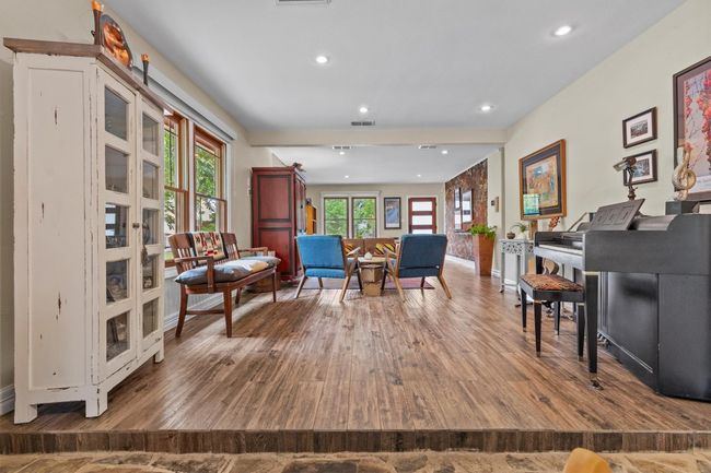 MAIN: Sitting room with recessed lighting, visible vents, and wood finished floors | Image 9
