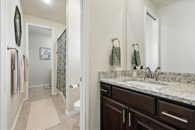 Bathroom with vanity, a shower with curtain, and tile patterned floors | Image 22