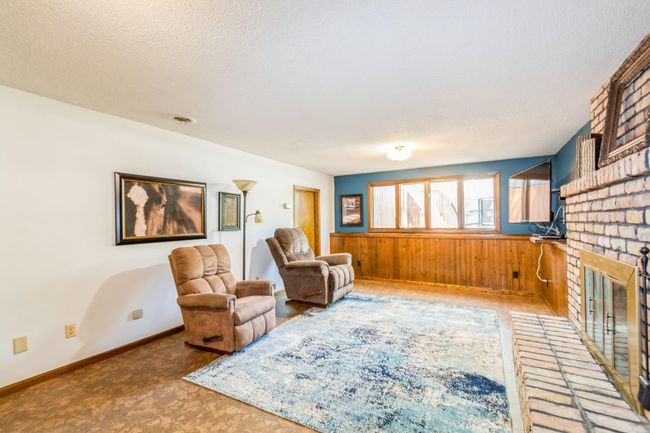 Bright lower level family room with wood burning fireplace. Behind the door is a finished bonus room! | Image 40