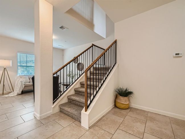 Stairway with baseboards and tile patterned floors | Image 6