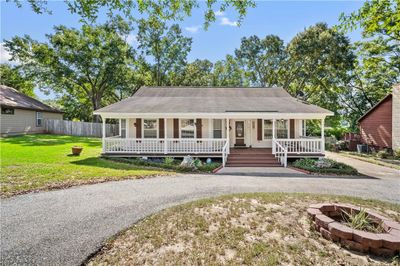 Country-style home featuring a front lawn and covered porch | Image 2