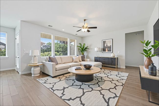 Living room with light wood-like tile floorings, ceiling fan, and recessed lighting (Virtual Staging) | Image 16