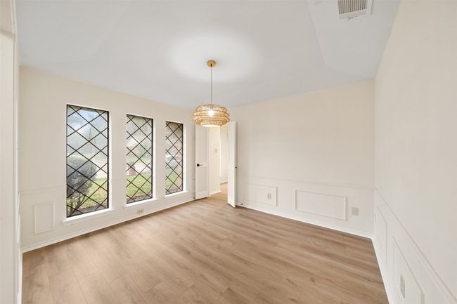 Dining room with wainscoting and lots of natural light | Image 5