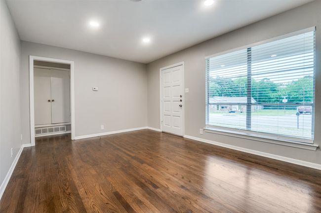 Living room featuring dark real wood flooring, baseboards, and recessed lighting | Image 7