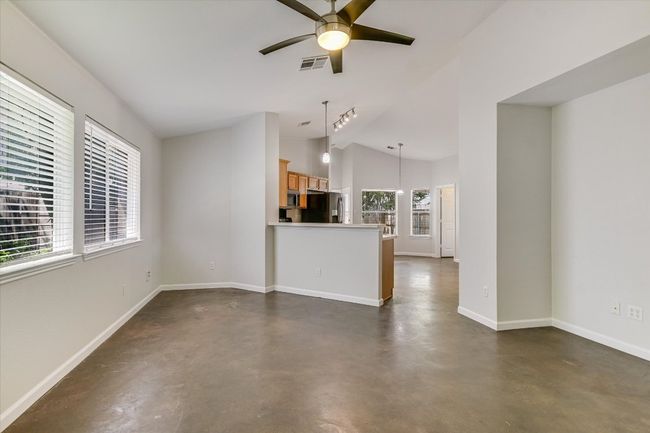 Light and bright and open with soaring ceilings making the space feel even larger. Living area is open to the kitchen so you don't miss a thing. There's room by the breakfast bar for a desk or what will you do with the space? | Image 4