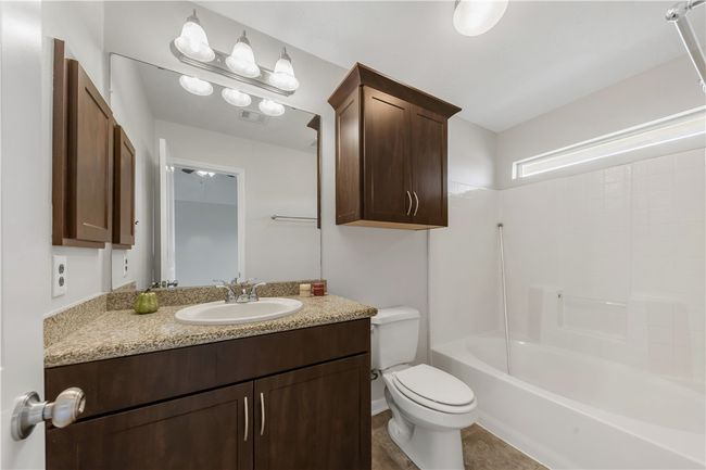 Bathroom with toilet, vanity, and shower combination | Image 12