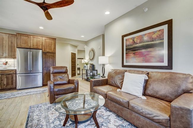 Living room with recessed lighting, ceiling fan, and light wood-style flooring | Image 11