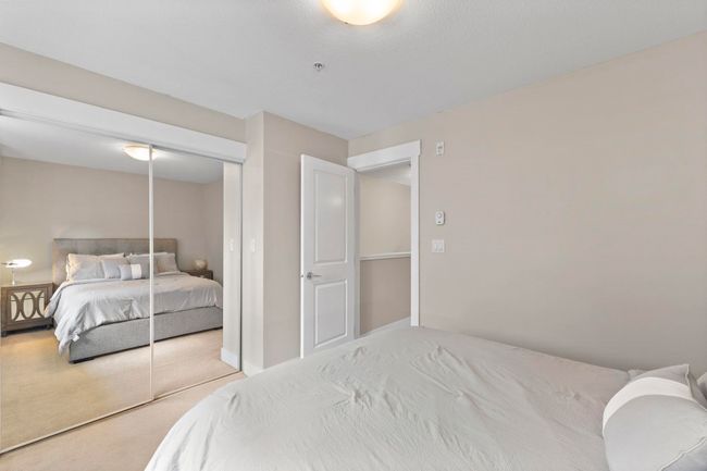 Carpeted bedroom with a closet | Image 14