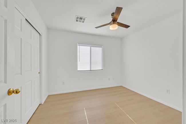 Unfurnished bedroom with light wood-style flooring, a closet, and ceiling fan | Image 13