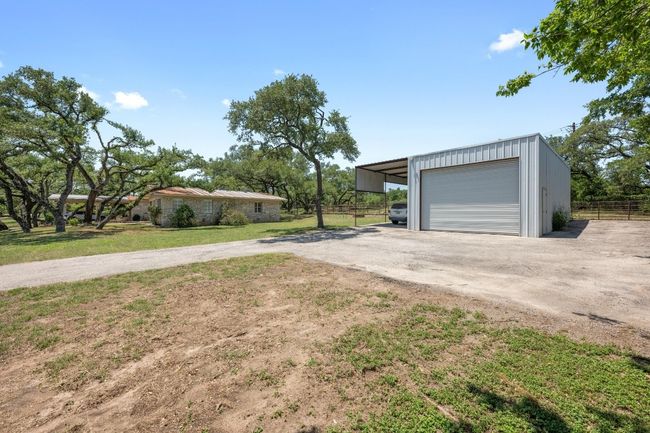 Large Industrial Metal Outbuilding with driveway and a carport. | Image 34