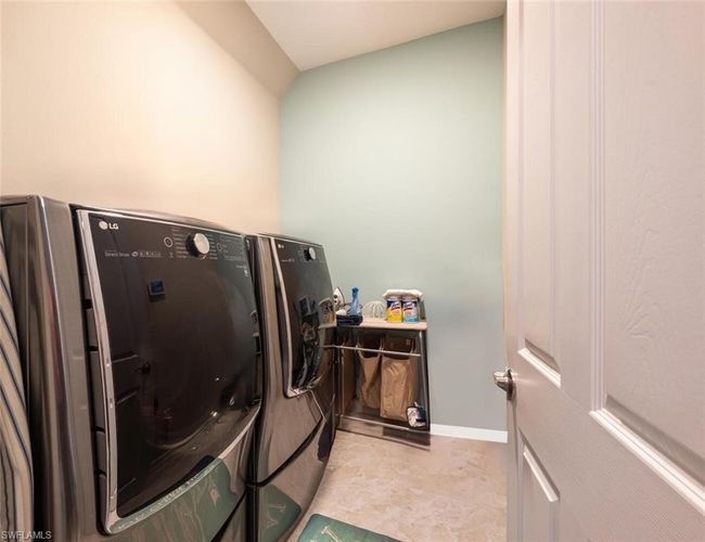 Washroom featuring washing machine and dryer and baseboards | Image 27