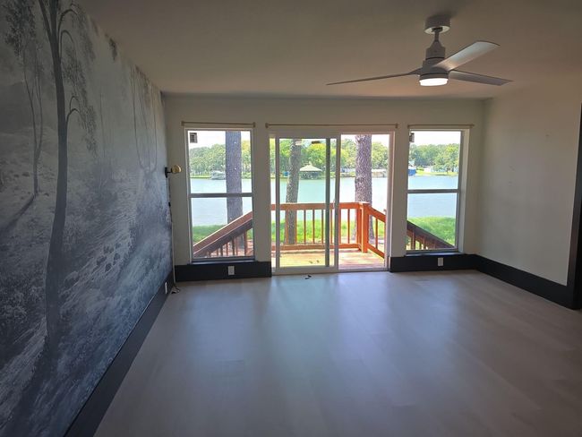 Unfurnished room featuring a water view, plenty of natural light, and a ceiling fan | Image 11