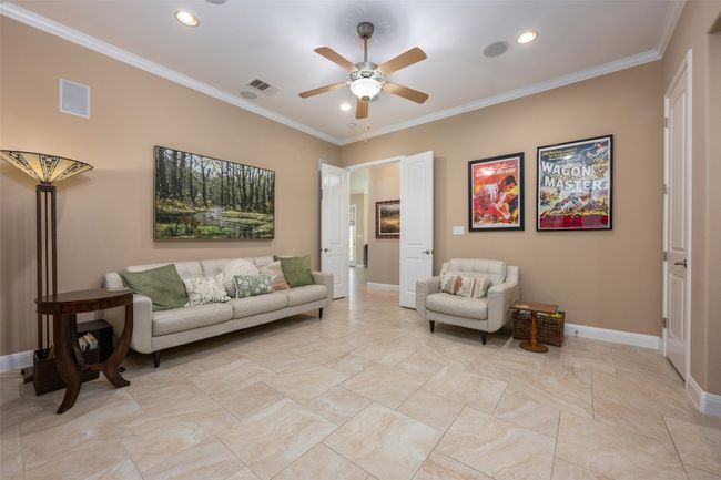 Living area featuring ceiling fan, crown molding, and recessed lighting | Image 25