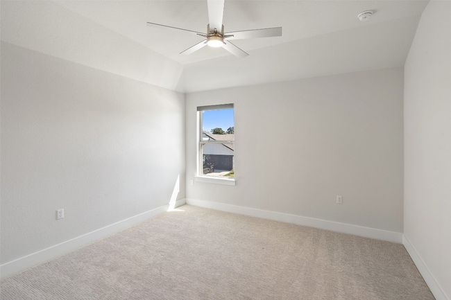 Spare room with light carpet, ceiling fan, and lofted ceiling | Image 28