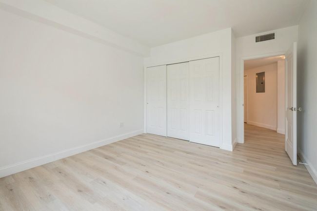 Unfurnished bedroom featuring electric panel, light wood-style flooring, and a closet | Image 15