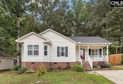 Beautifully landscaped front yard with charming entryway, setting the tone for this well-maintained | Image 1