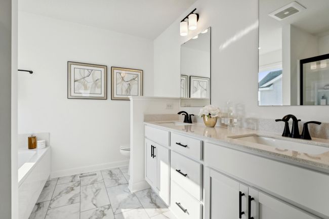 (Photo of a decorated model, actual homes finishes will vary) Be impressed with the large primary bedroom that offers its own private ensuite bath and walk-in closet. | Image 10