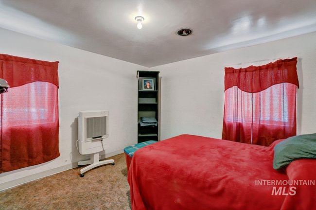Carpeted bedroom featuring heating unit | Image 25