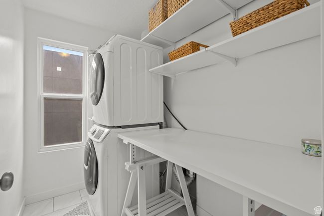 Washroom featuring stacked washer / dryer with space for folding or to do side by side. | Image 36