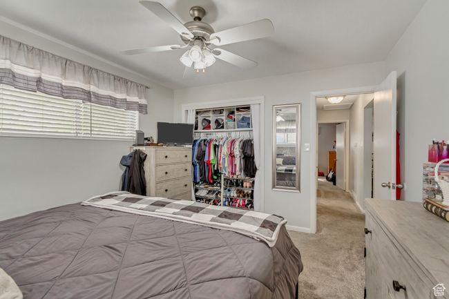 Bedroom with a ceiling fan, a closet, and light colored carpet | Image 10