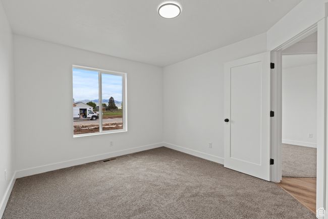 Unfurnished bedroom featuring carpet floors and baseboards | Image 17