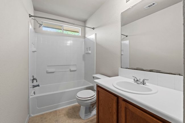 This full bathroom includes tile flooring and a bathtub/shower combo. | Image 22