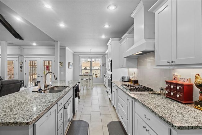 What a great view to the back yard with double French doors to the back patio and window in the breakfast room. | Image 12