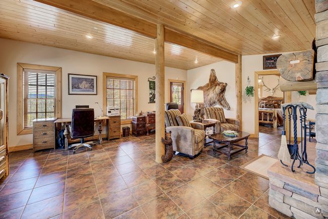 Living room featuring an office area, wood ceiling, and recessed lighting | Image 44