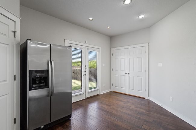 Kitchen with stainless steel fridge with ice dispenser, dark wood-type flooring, recessed lighting, and french doors | Image 20