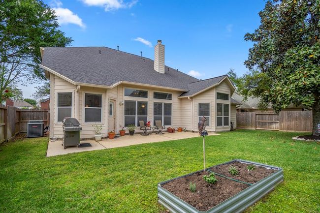 Looking back at the home, the spacious patio is visible, offering an inviting outdoor space for relaxation and entertaining. | Image 35