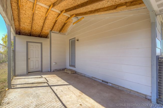 Covered carport w/small storage closet. | Image 36