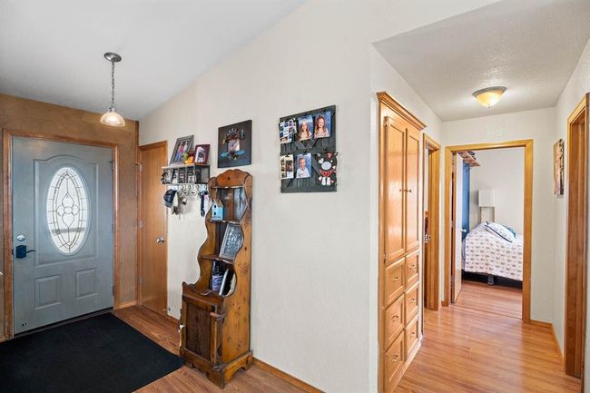 Entrance foyer featuring light wood finished floors, baseboards, and vaulted ceiling | Image 15